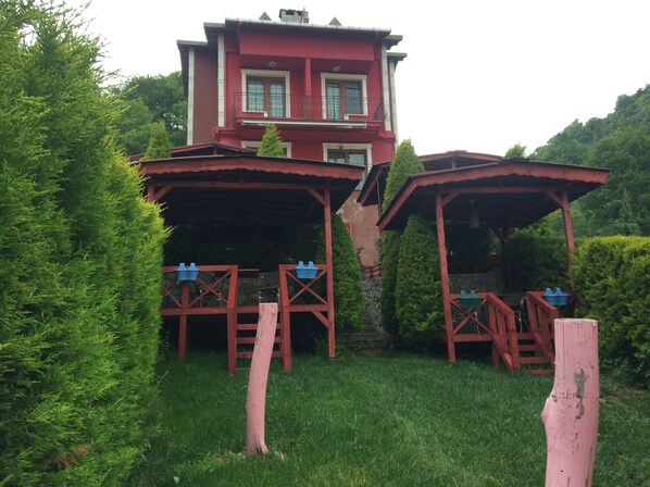 A two-story house with a red exterior, a balcony, and a covered porch area. - Agva Heaven Hill (Sile)