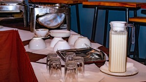 A table with various glassware, including tumblers and a pitcher, set on a tablecloth. - Le Savanna Country Lodge And Hotel (Kisumu)