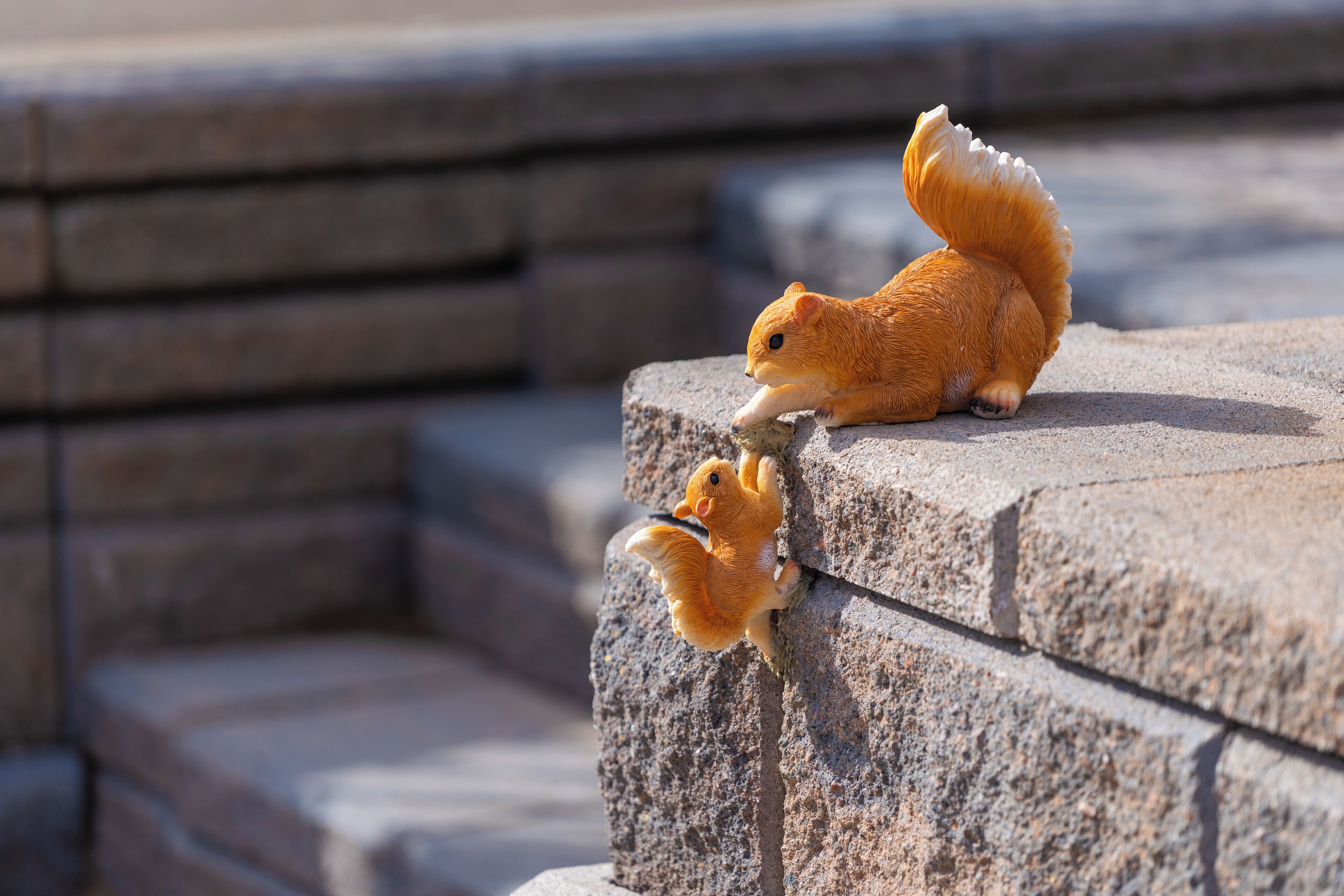 A squirrel on a stone ledge.