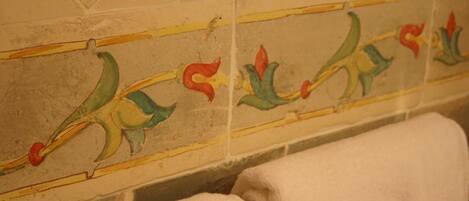A tiled wall with a floral pattern.