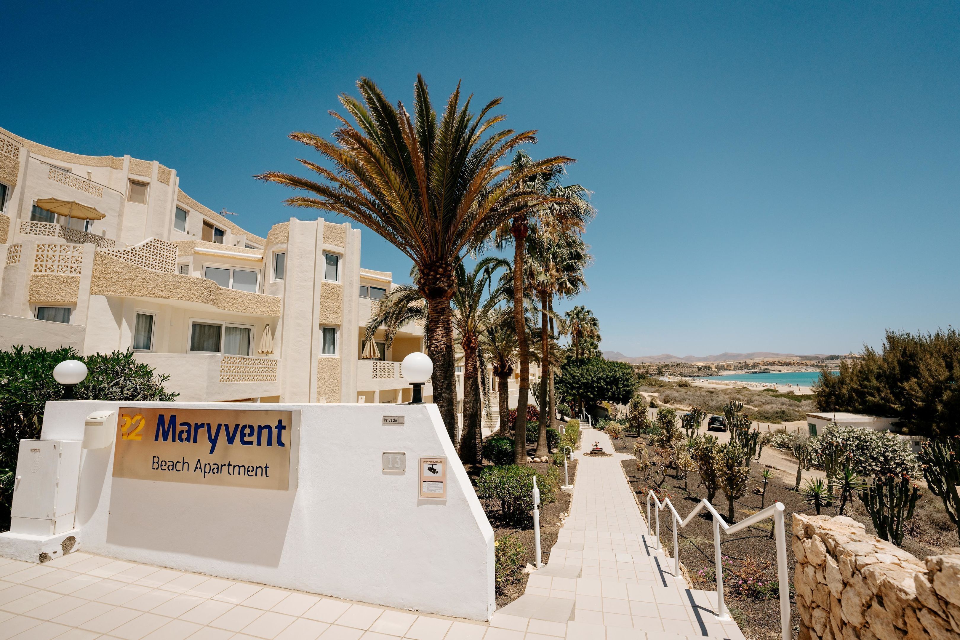 A Maryvent Beach Apartment with a view of the beach and palm trees.