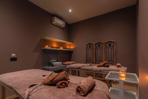 A spa room with two massage tables, a sink, and a mirror. - Zante Sun Resort (Zakynthos)