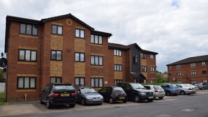 A multi-story residential building with a parking lot. - granary (London)