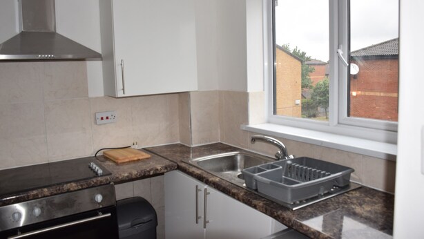 A kitchen with a stove, sink, and window. - granary (London)