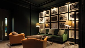 A modern lounge with leather armchairs, a green sofa, and a coffee table. - Hotel Indigo Dundee by IHG (Dundee)