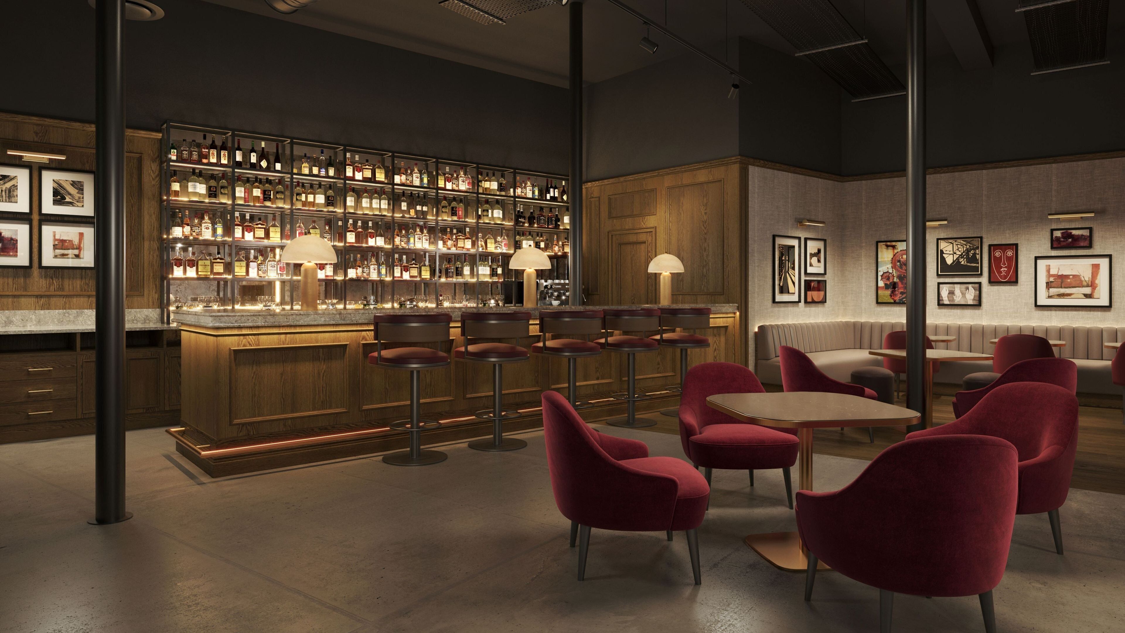 A bar area with multiple stools, a bar counter, and a wall of liquor bottles.