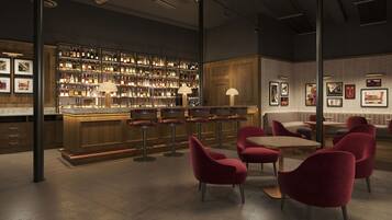 A bar area with multiple stools, a bar counter, and a wall of liquor bottles.