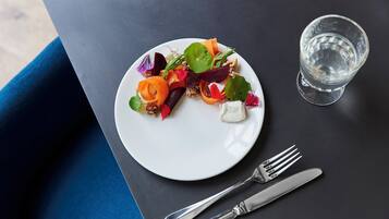 A plate of food with a fork and knife beside it on a table.