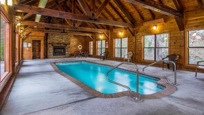 A wooden cabin with a large indoor swimming pool, stone fireplace, and large windows. - Moose Hollow Lodge (Sevierville)