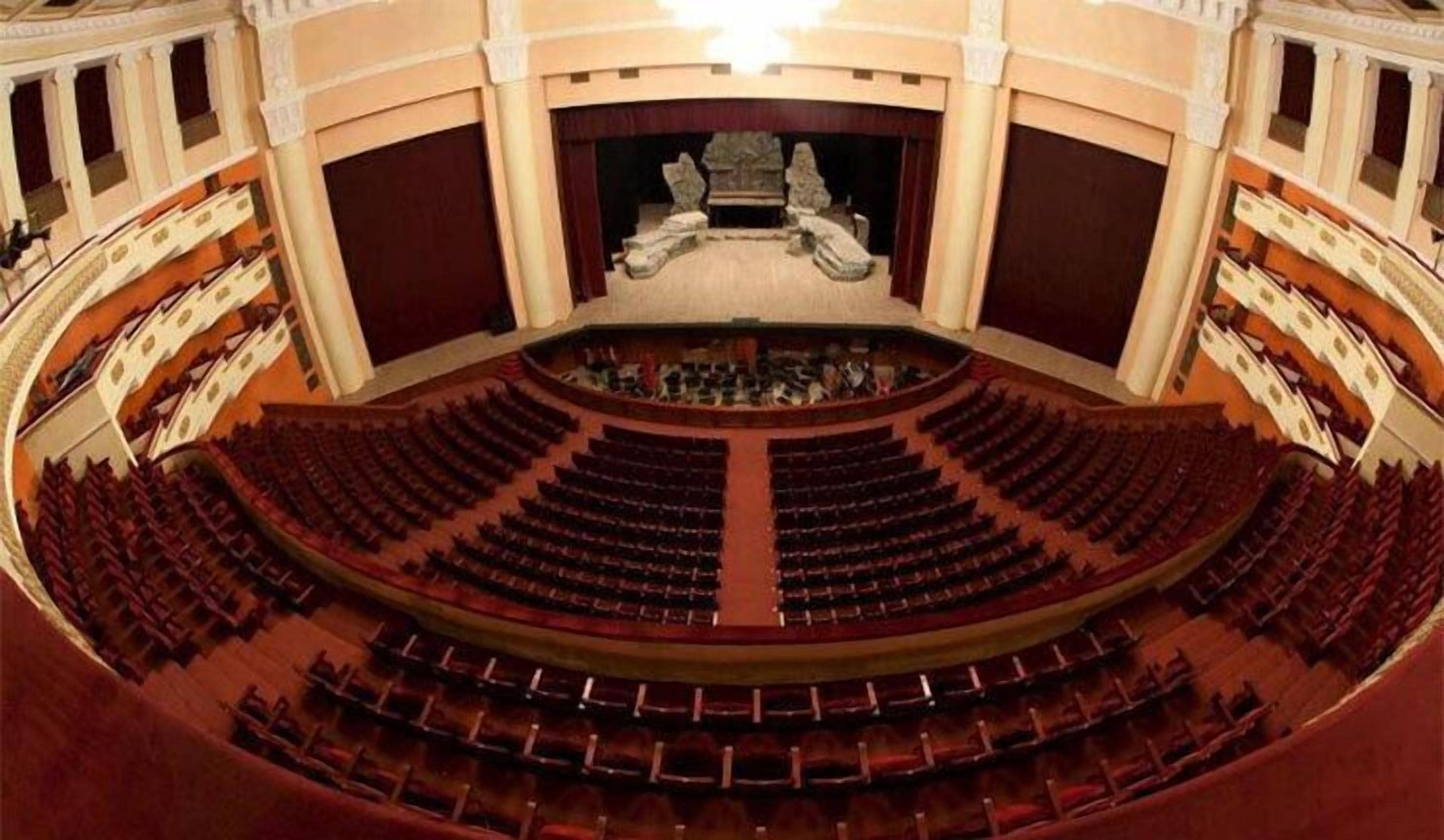 A large, circular auditorium with tiered seating and a central stage.