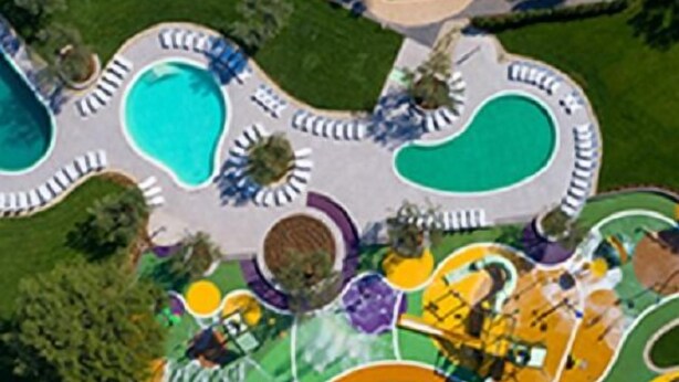 An aerial view of a resort with multiple swimming pools, landscaped areas, and a central building. - Accommodation Stosic (Rovinj)