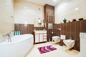 Enjoy a relaxing soak in the bathtub and get ready for the day at the vanity with a mirror.
