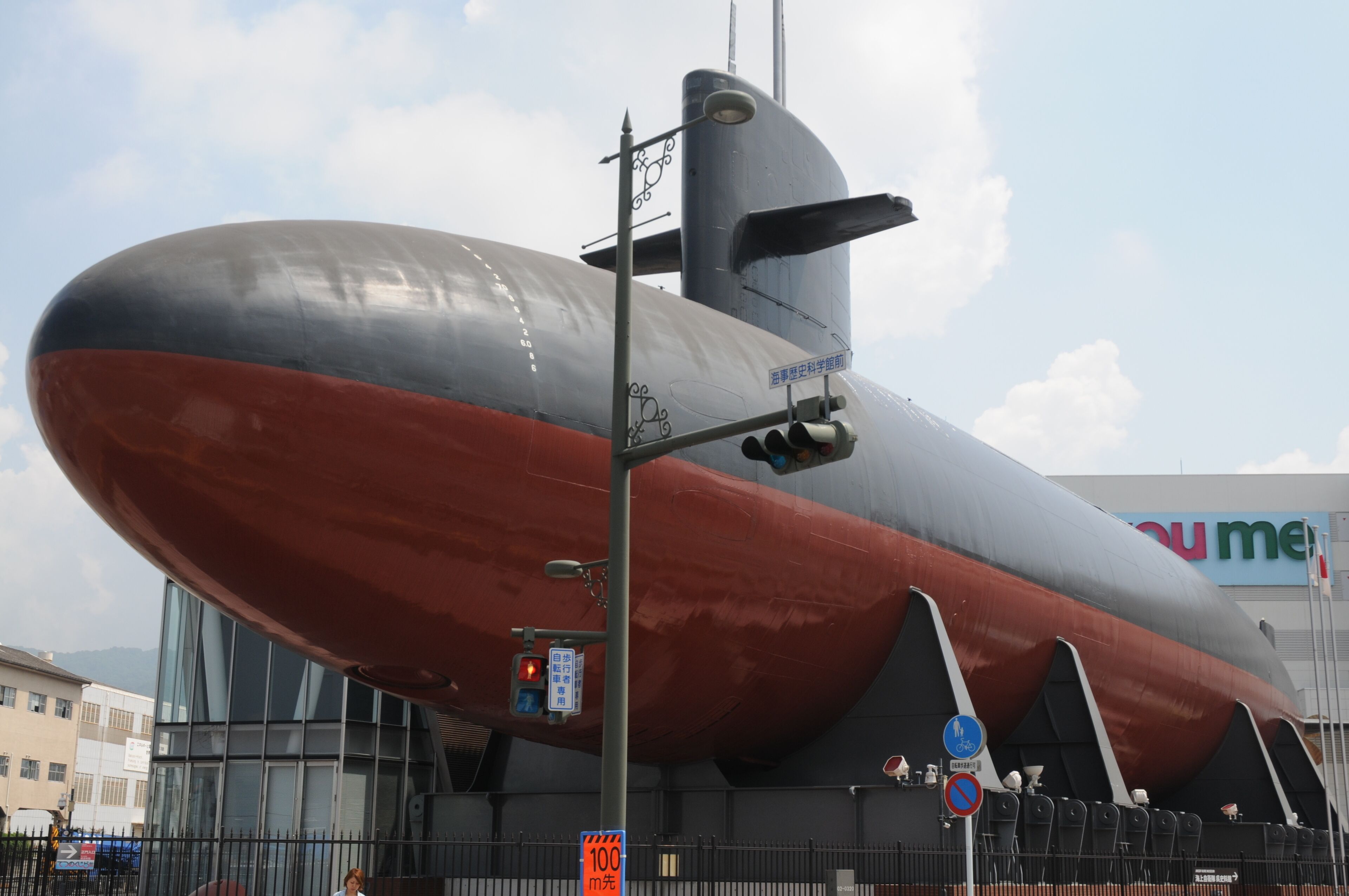 A large, modern building with a unique architectural design, featuring a prominent, curved structure.