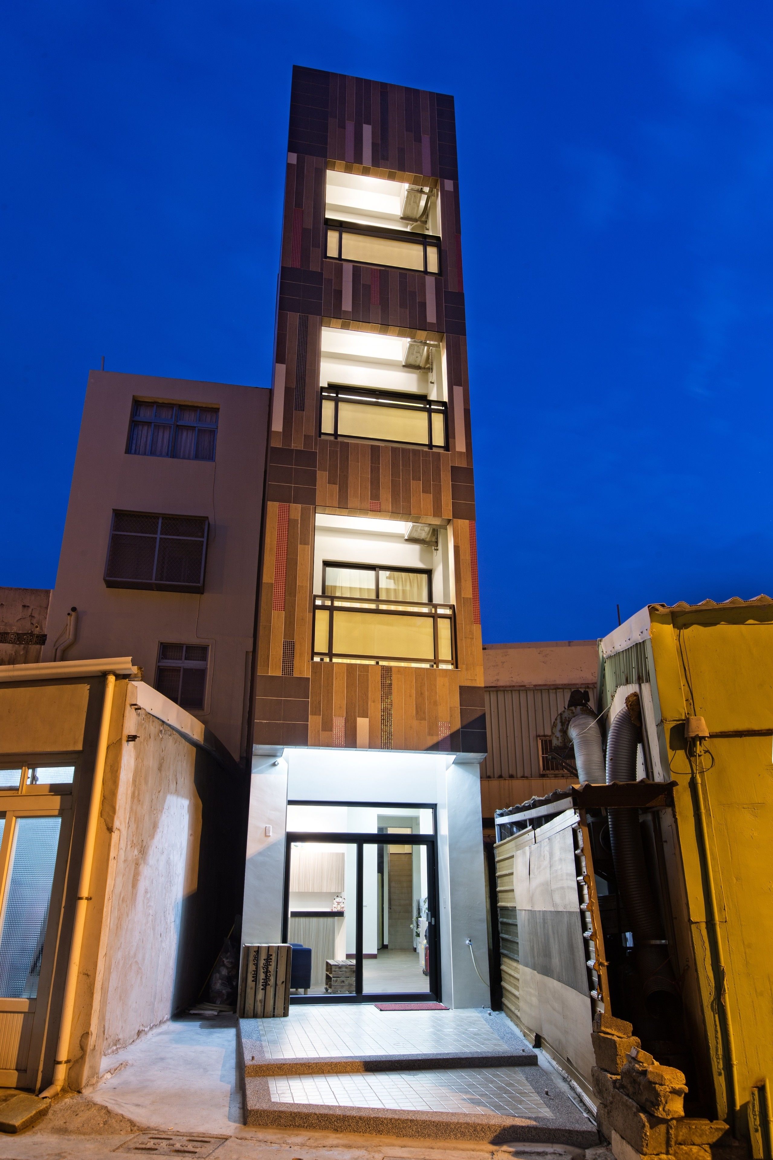 A modern building with a prominent entrance and multiple windows.