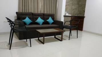 Family Suite, 1 Bedroom (Living Room) | Living area | 42-inch TV with satellite channels