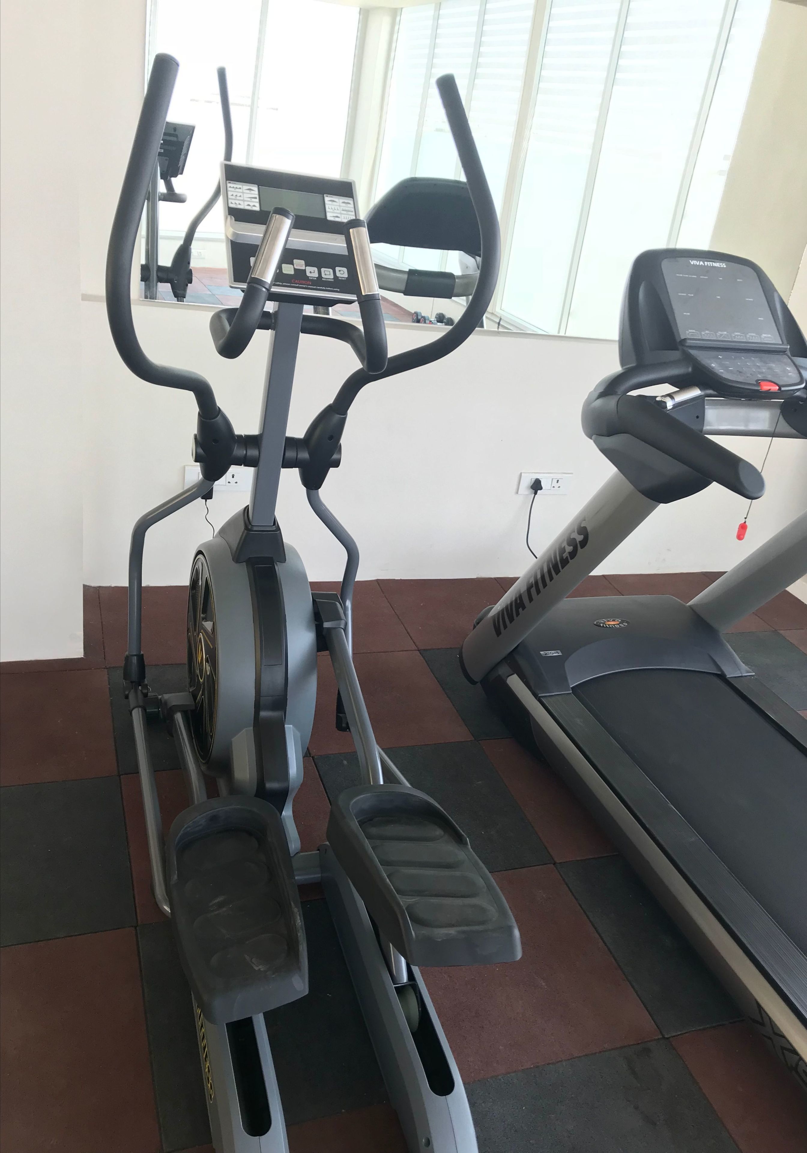 An exercise machine with a digital display and a treadmill.