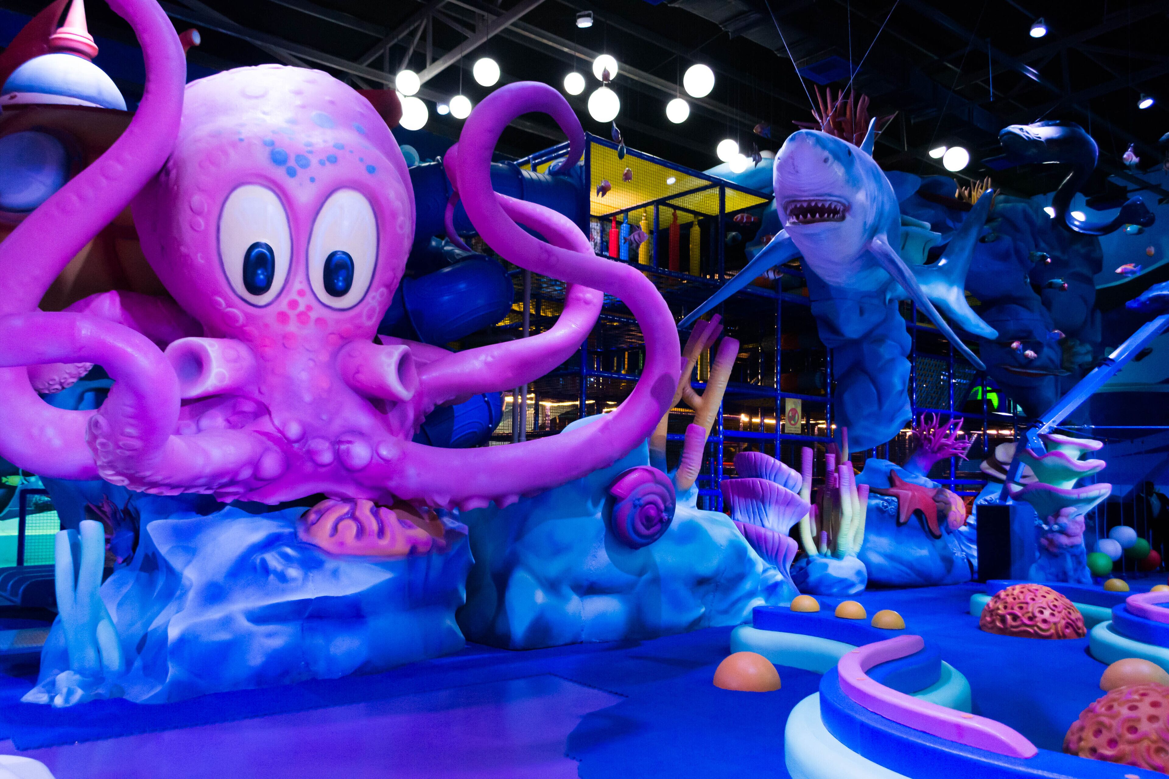A large, colorful indoor play area with various sea-themed structures and decorations.