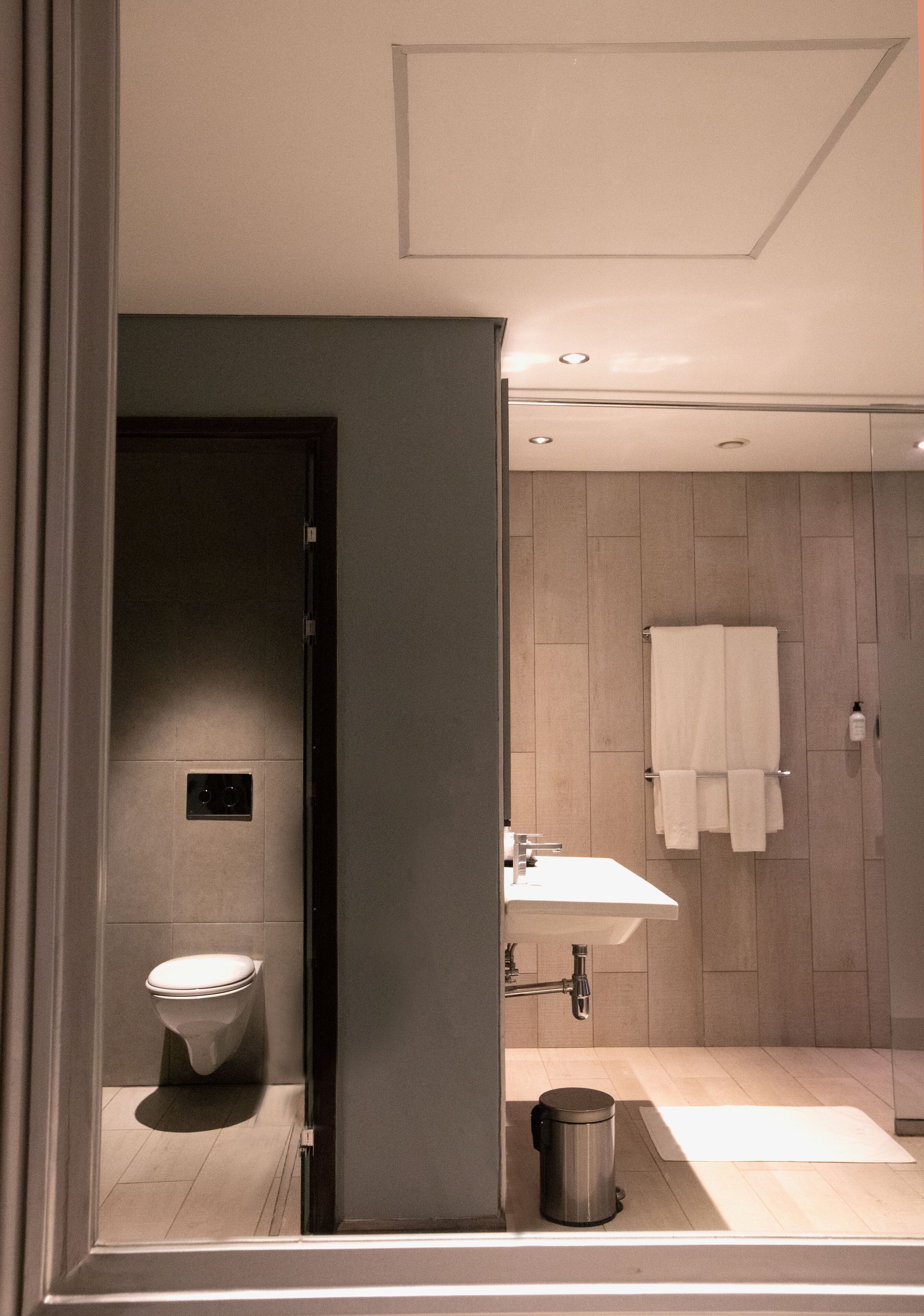 A modern bathroom with a toilet, sink, and shower area.