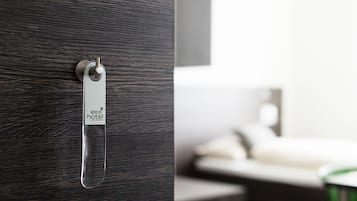 Quarto de hotel com porta de madeira e suporte para cartão-chave.