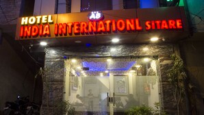 A hotel entrance with a sign reading "Hotel India International Sitare."