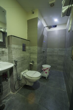 A bathroom with a toilet, bidet, and sink.