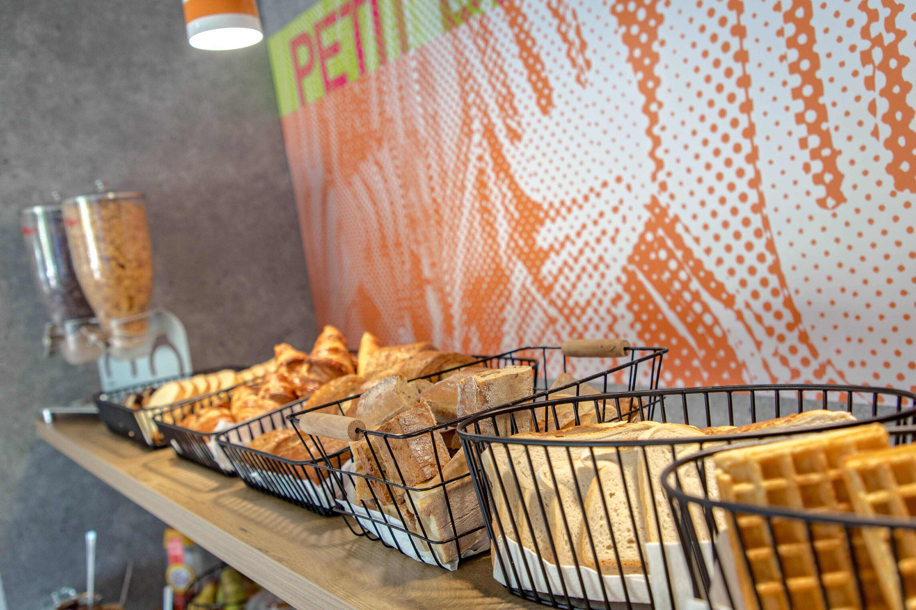 A buffet with various breads and waffles.