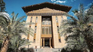 A building with a symmetrical facade, large windows, and a central entrance. - LUX Tea Horse Road Deqin Benzilan (Chuxiong Yi)