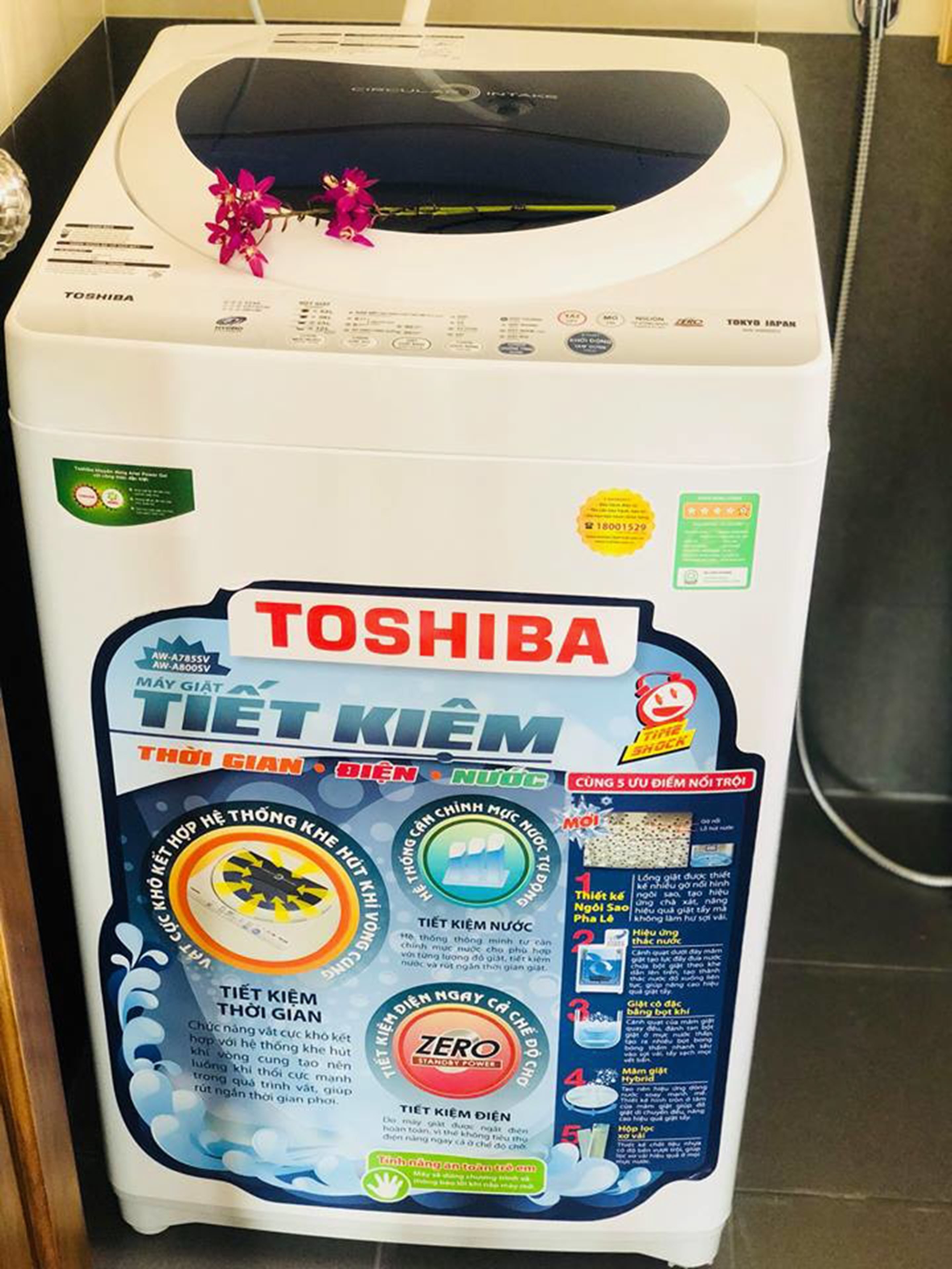 A Toshiba washing machine with a front panel displaying various features and instructions.