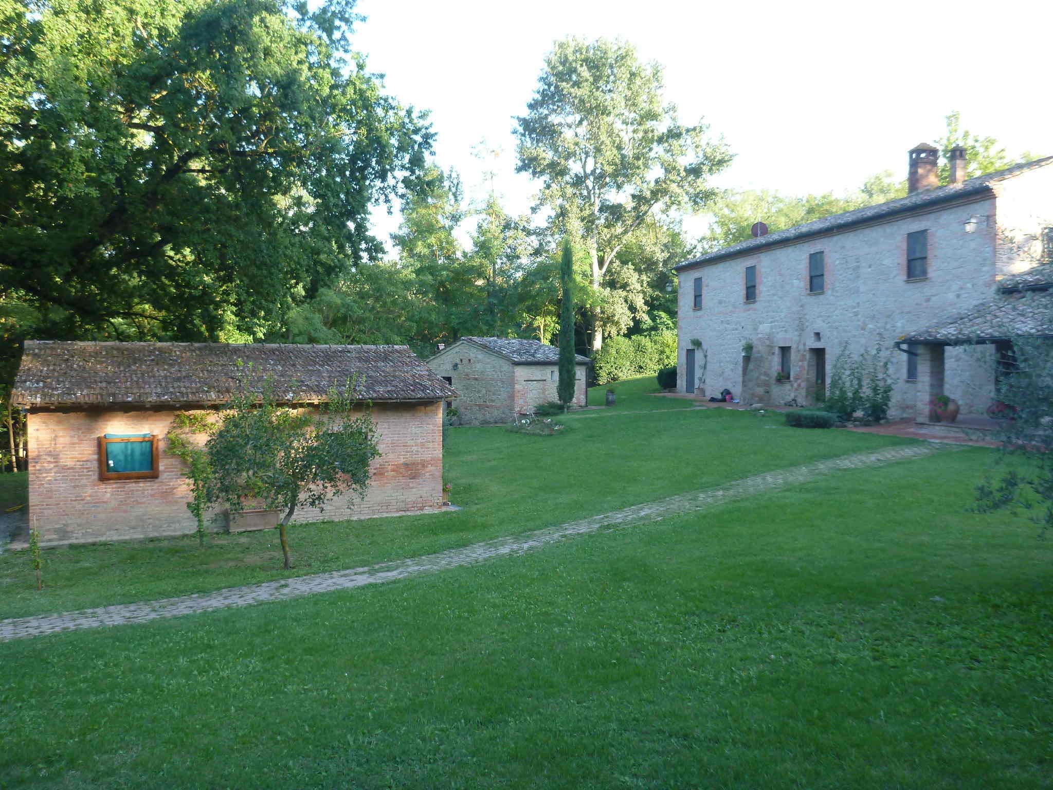 A rustic stone building with a small garden area in front.