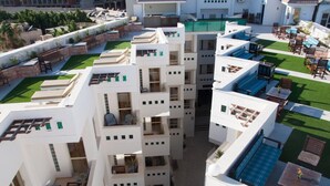 A multi-story hotel with outdoor seating areas, balconies, and a pool. -  Fantasia Hotel (Hurghada)