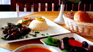 A dining table with a plate of rice, a bowl of soup, and a basket of bread. -  Fantasia Hotel (Hurghada)
