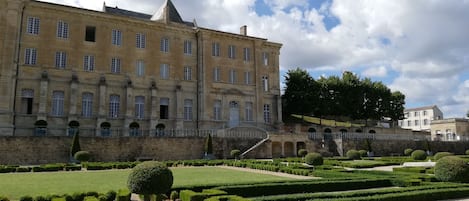 A historic building with a symmetrical facade, large windows, and a central tower.