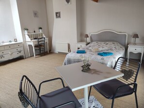 A bedroom with a bed, bedside tables, a desk, a chair, and a radiator. - Les Chenêts (Chenay)