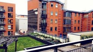A modern building with multiple floors, large windows, and a flat roof. - Birmingham Serviced Apartment- Ryland (Birmingham)