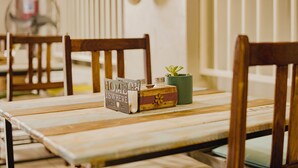 A wooden table with a small potted plant and a decorative box. - Kate's Nest Guesthouse (Windhoek)