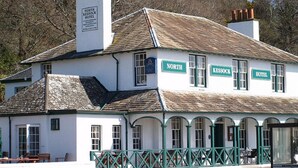A traditional building with a sign reading "North Kessock Hotel" and a visible staircase leading to the entrance. - North Kessock Hotel (Inverness)