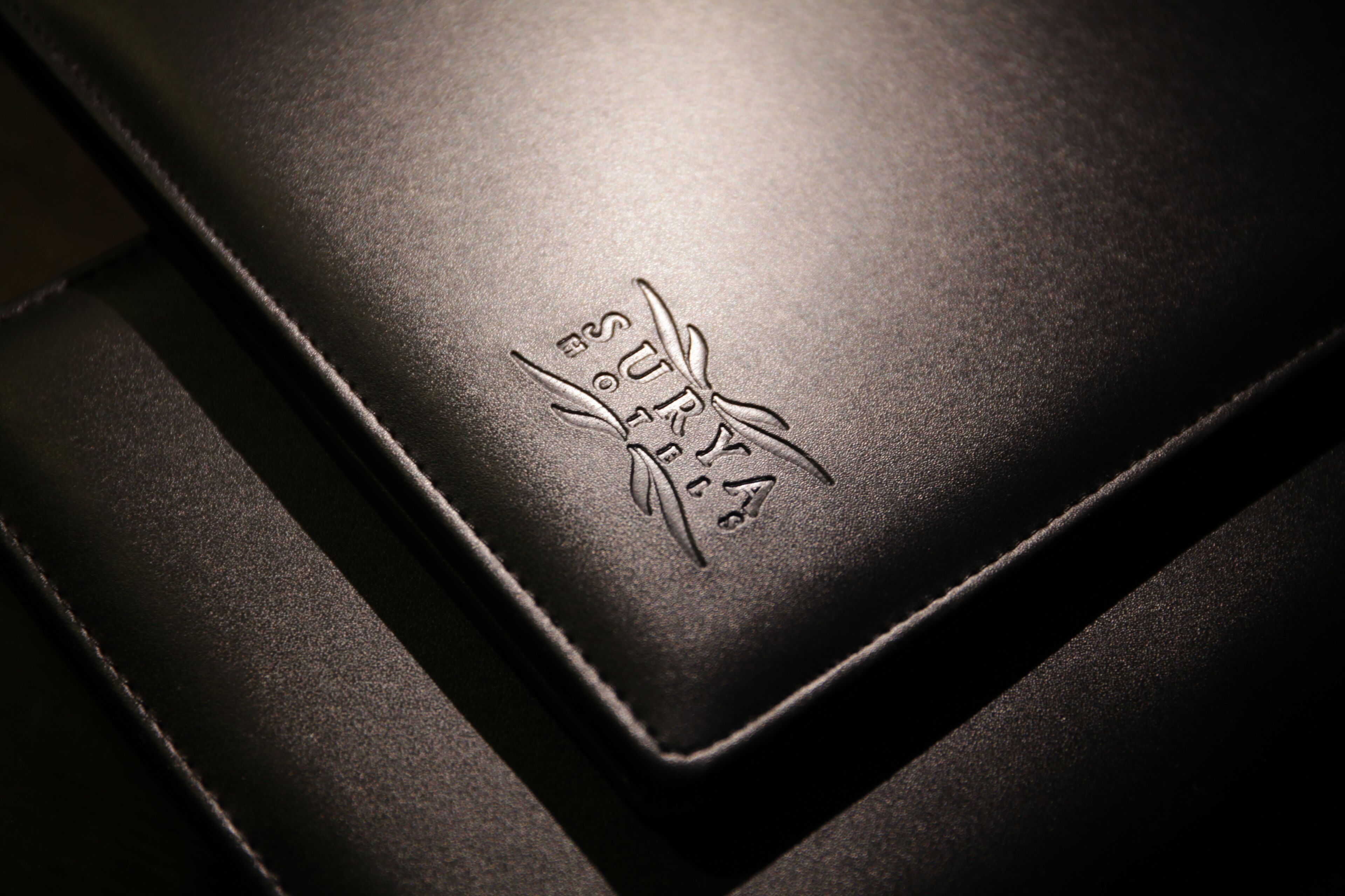 A close-up of a textured surface with embossed text and a design.