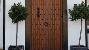 The entrance to the New Crown Inn, featuring a wooden door with a sign above it.