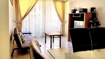 Standard Apartment, 3 Bedrooms, 2 Bathrooms | Living area | Flat-screen TV