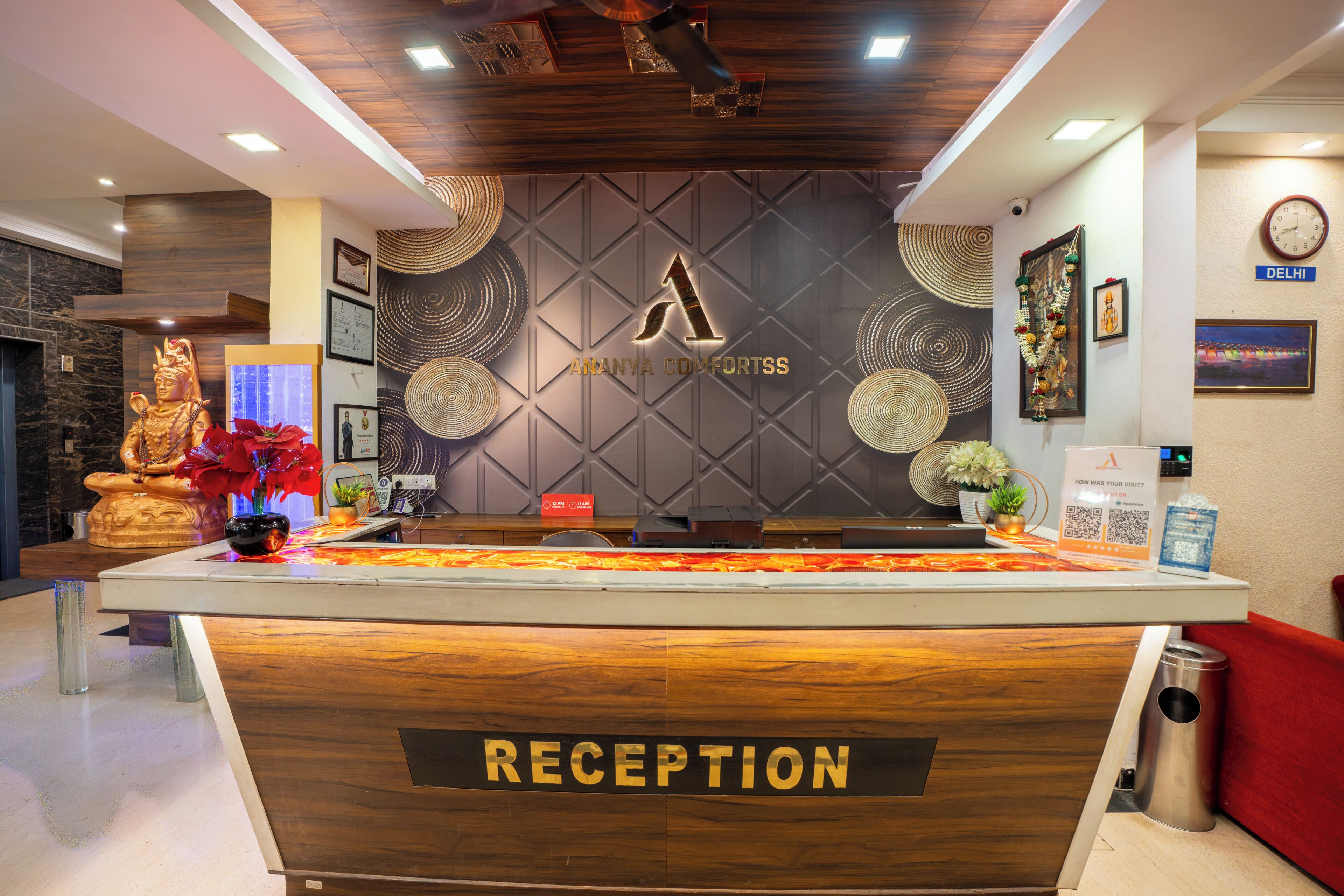 A reception desk with a wooden finish, a sign reading 'RECEPTION,' and a logo above it.
