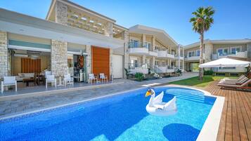 A modern hotel with a swimming pool featuring a swan float.