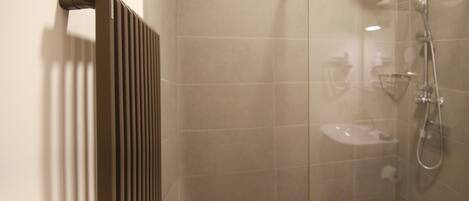 A bathroom with a shower, toilet, and sink.