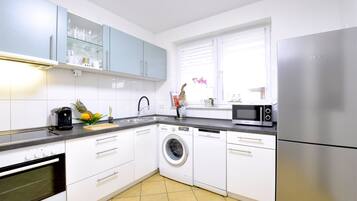 Comfort Apartment | Private kitchen | Full-size fridge, microwave, stovetop, coffee/tea maker