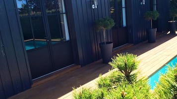 Seasonal outdoor pool, open 5:00 PM to 8:00 PM, pool umbrellas