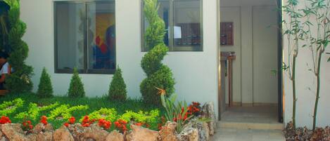 A modern building with a stone pathway leading to a door.