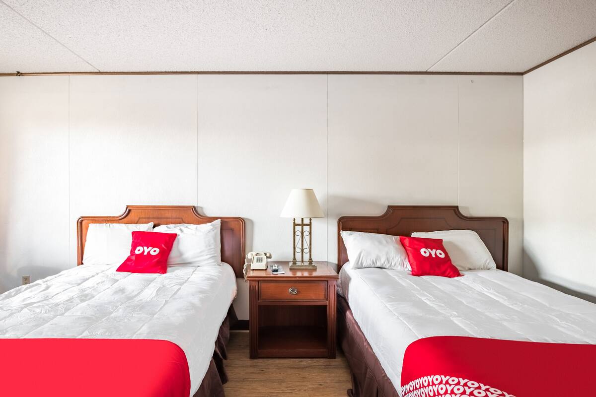 Desk, iron/ironing board, bed sheets