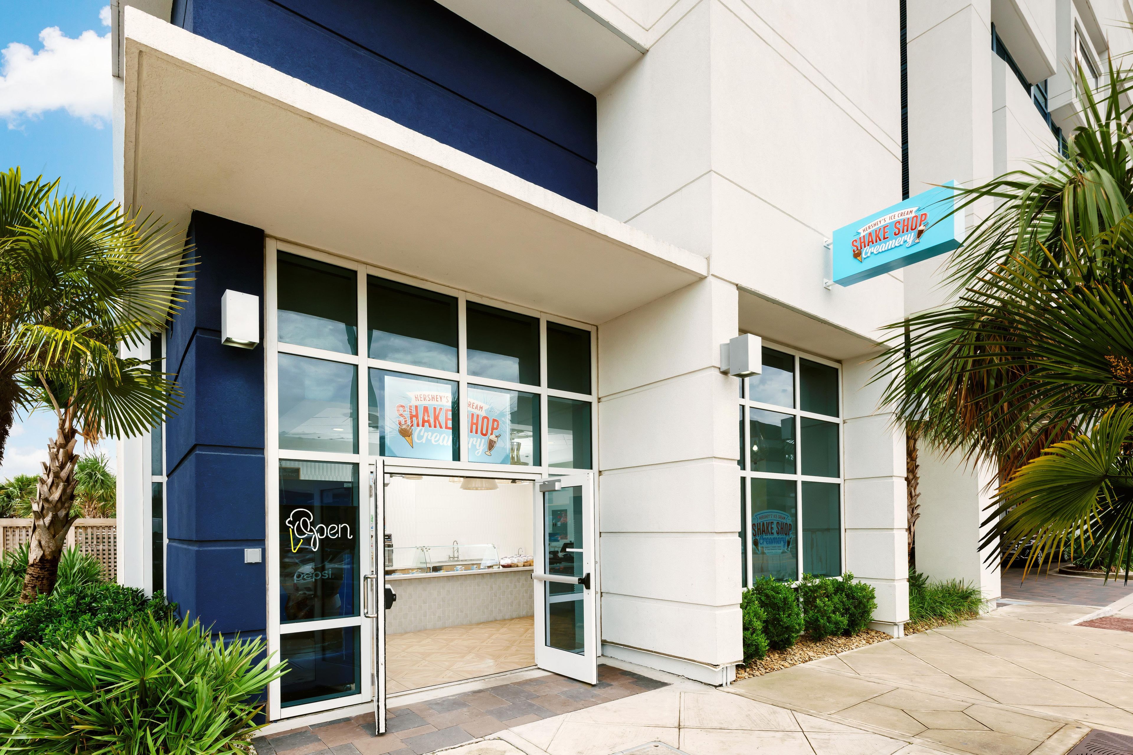 A commercial building with a storefront featuring a sign for a shake shop.