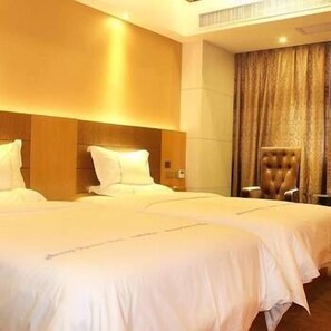 A hotel room with two beds, a wooden headboard, a large window with curtains, and a plush armchair. - West Lake Hotel (Shenzhen)