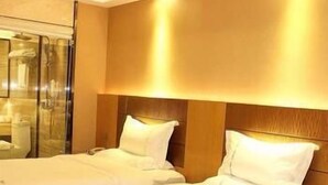 A hotel room with two beds, a wooden headboard, and a glass shower enclosure. - West Lake Hotel (Shenzhen)