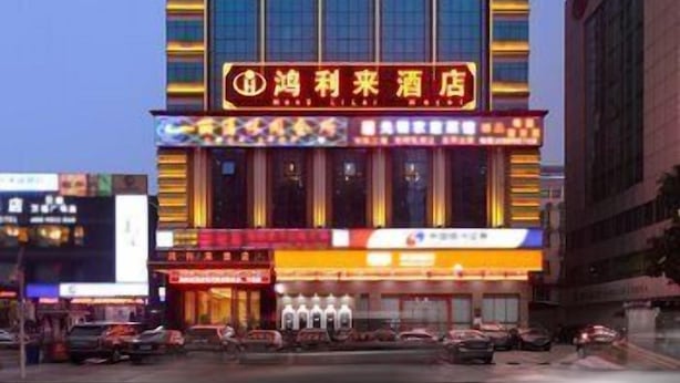 A hotel with a prominent sign for 'Hong Le Hotel' and multiple balconies.